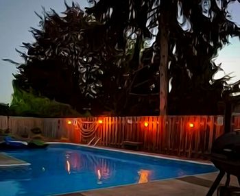 Swimming pool against sky at night