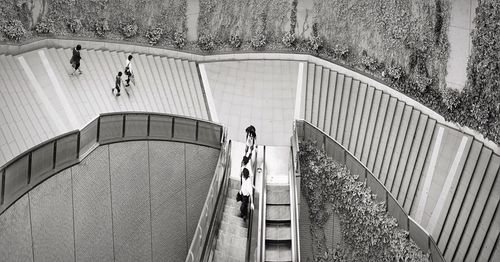 High angle view of people walking on staircase