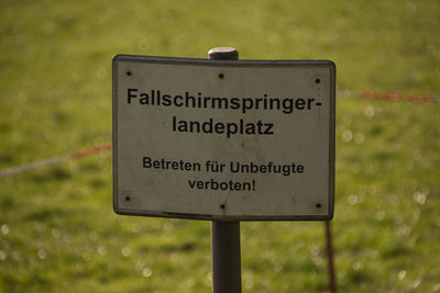 Close-up of signboard on field