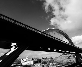 Low angle view of bridge against sky in city