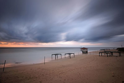 Scenic view of beach against sky during sunset