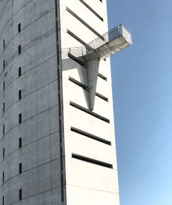 Low angle view of modern building against clear blue sky