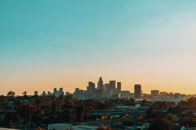 Cityscape against sky during sunset