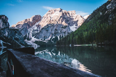 Scenic view of lake by mountains against sky