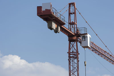 Low angle view of crane against sky