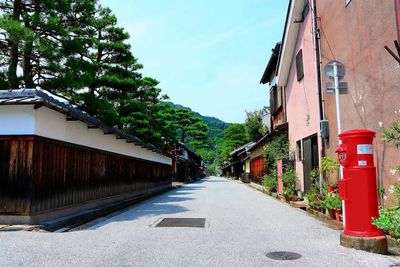 Street amidst buildings against sky