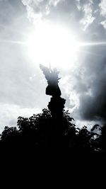 Low angle view of statue against cloudy sky