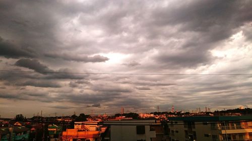 Buildings against cloudy sky