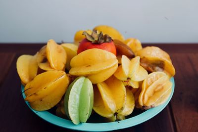Close-up of chopped fruits in bowl on table