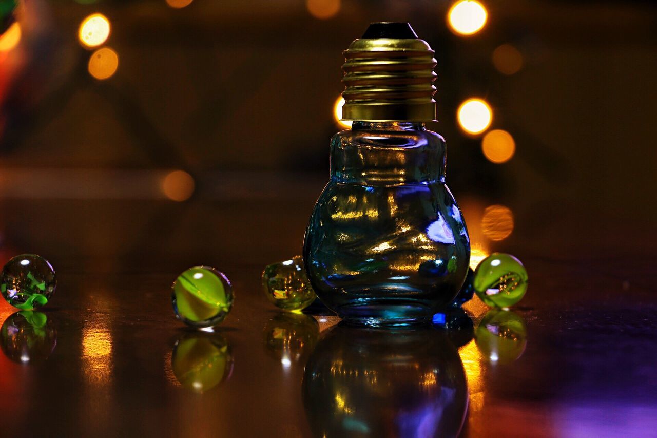 indoors, illuminated, glass - material, table, transparent, close-up, reflection, focus on foreground, lighting equipment, still life, drinking glass, glowing, selective focus, wineglass, glass, no people, lens flare, decoration, drink, electric light