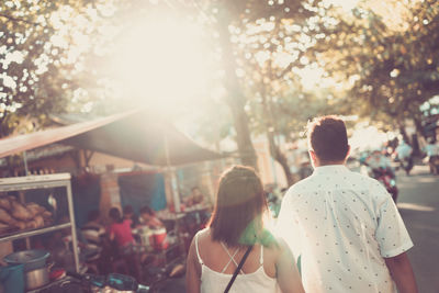 Rear view of couple walking outdoors