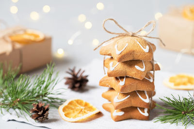 Christmas food. homemade gingerbread cookies, pine branches, cones, dried oranges. 