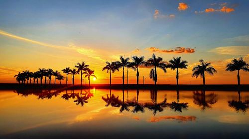 Scenic view of lake against sky during sunset