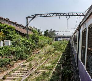 Train on railroad tracks against clear sky