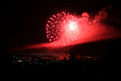 Colorful firework display over town