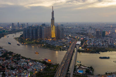 High angle view of city buildings against cloudy sky