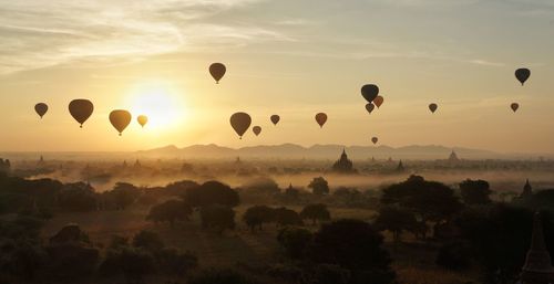 Silhouette of hot air balloons flying in sky