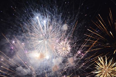 Low angle view of firework display at night