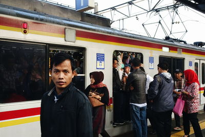 People standing on bus in city