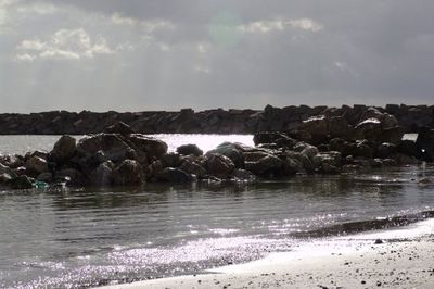 Scenic view of sea against cloudy sky