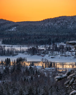 Scenic view of lake against sky during sunset