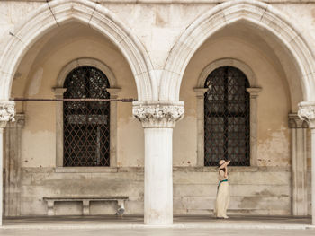 Woman walking on saint mark's square in front of doge's palace in venice