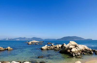 Scenic view of sea against clear blue sky