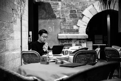 Woman sitting on table in restaurant