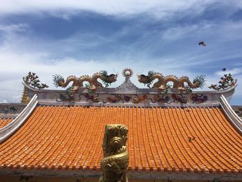 Multicolored chinese dragon against blue sky, beautiful dragon in chinese temple with blue sky