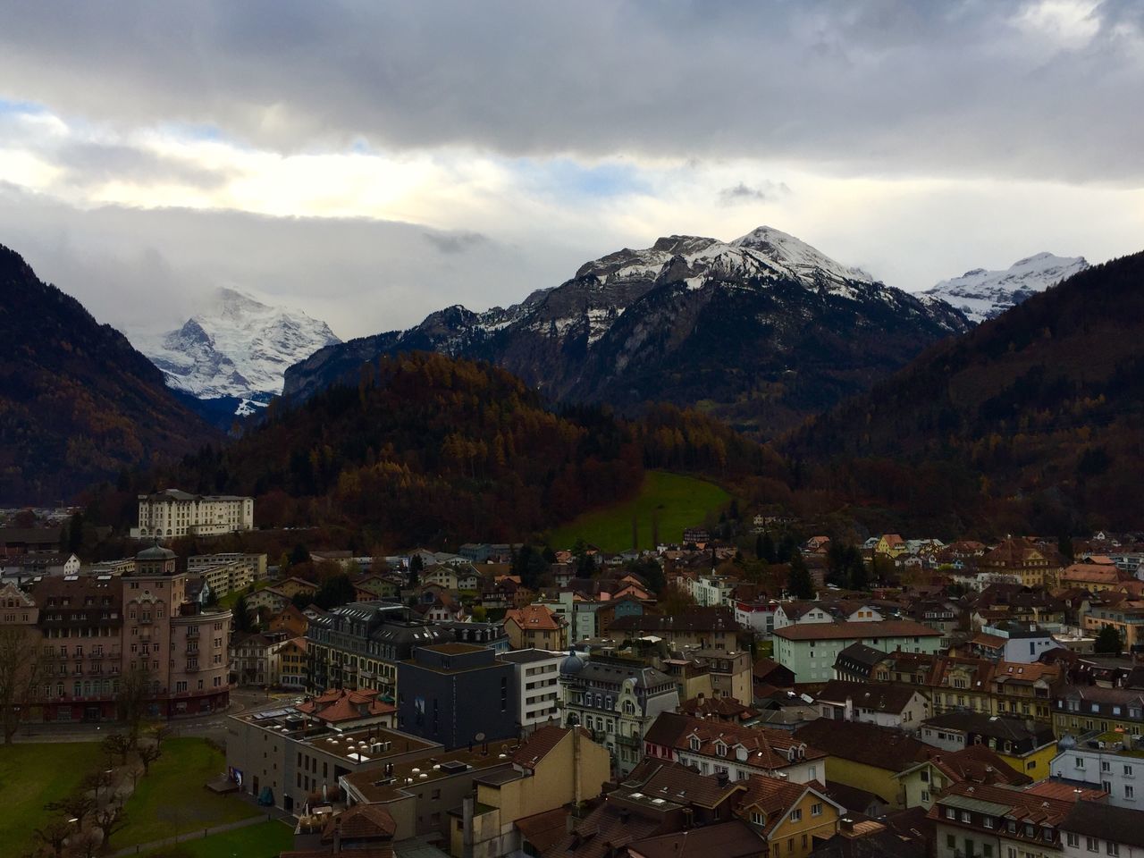 mountain, architecture, built structure, building exterior, mountain range, sky, cloud - sky, city, town, house, cityscape, travel destinations, residential building, outdoors, nature, no people, scenics, day