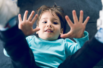 Cute boy gesturing at home