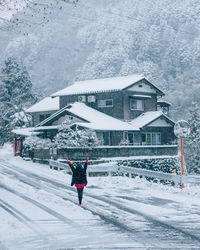 Rear view of man on snow against sky