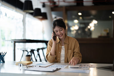 Smiling businesswoman working at office