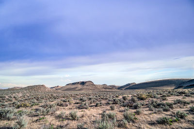 Scenic view of arid landscape against sky