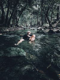 High angle view of shirtless man swimming in river