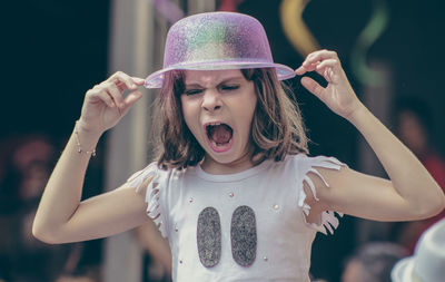 Close-up portrait of happy girl standing outdoors