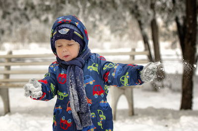 Full length of cute boy in snow
