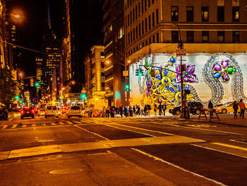 Illuminated city street at night