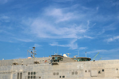 Low angle view of buildings against blue sky