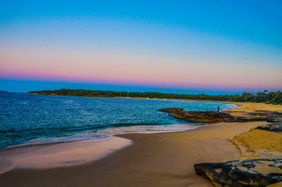 Scenic view of sea against clear blue sky