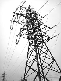 Low angle view of electricity pylon against sky