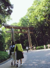 Rear view of people walking in park