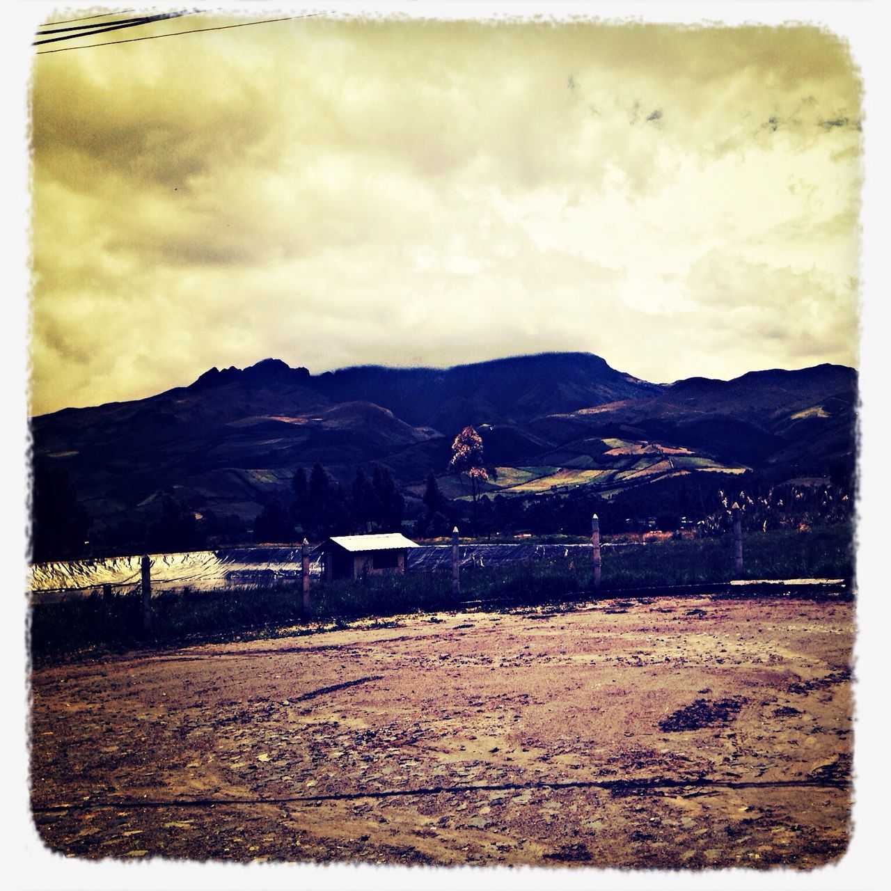 sky, mountain, transfer print, cloud - sky, auto post production filter, cloudy, landscape, mountain range, cloud, built structure, building exterior, architecture, overcast, tranquil scene, scenics, outdoors, nature, transportation, tranquility, fence