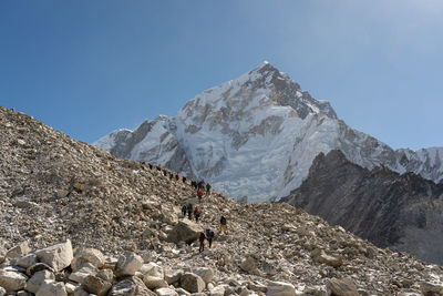 Scenic view of snowcapped mountains against clear blue sky