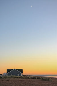 View of house against clear sky during sunset