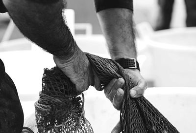 Close-up of man holding fishing net