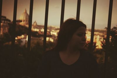 Close-up of young woman against sky during sunset