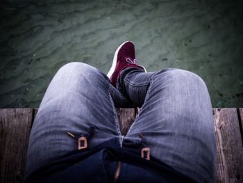 Low section of man sitting outdoors