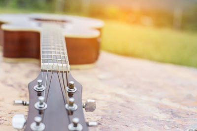 Close-up of guitar on table