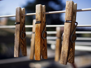 Close-up of clothespins hanging on clothesline